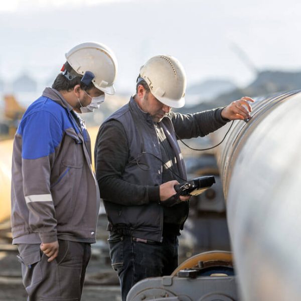 two-men-inspecting-pipeline two-men-inspecting-pipeline